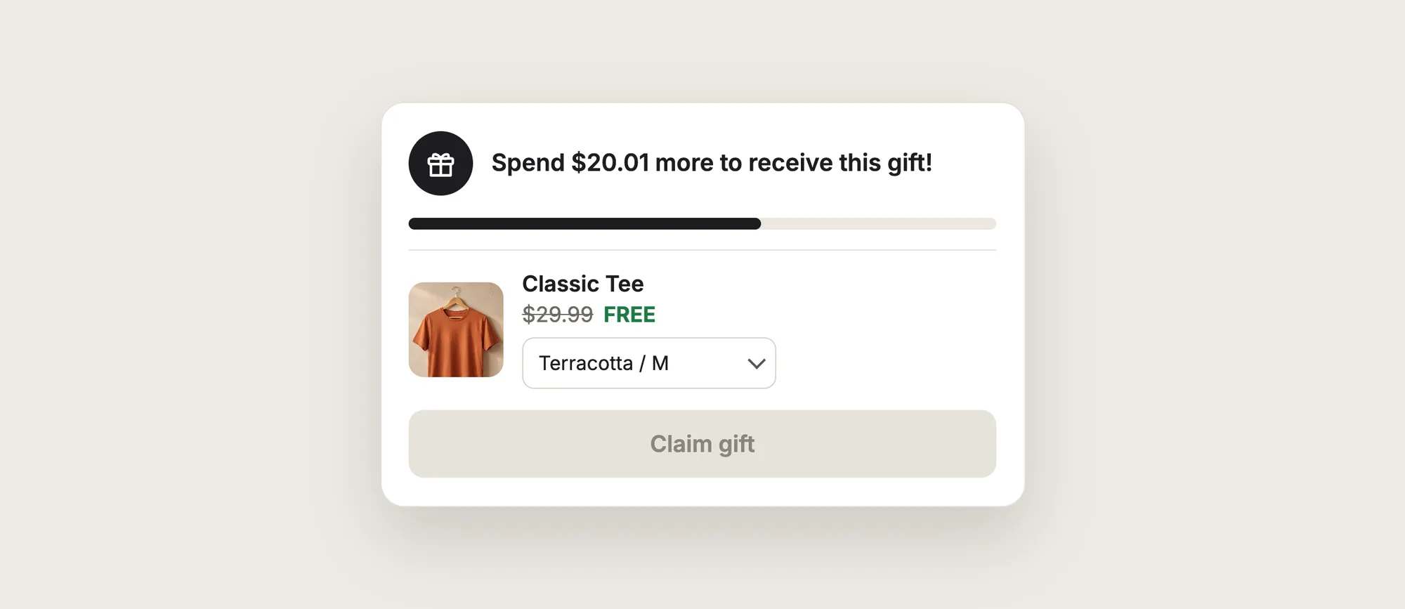 Close-up of a free gift with purchase widget with a gift icon, a progress bar, a free Classic Tee with a variant dropdown and a Claim gift button