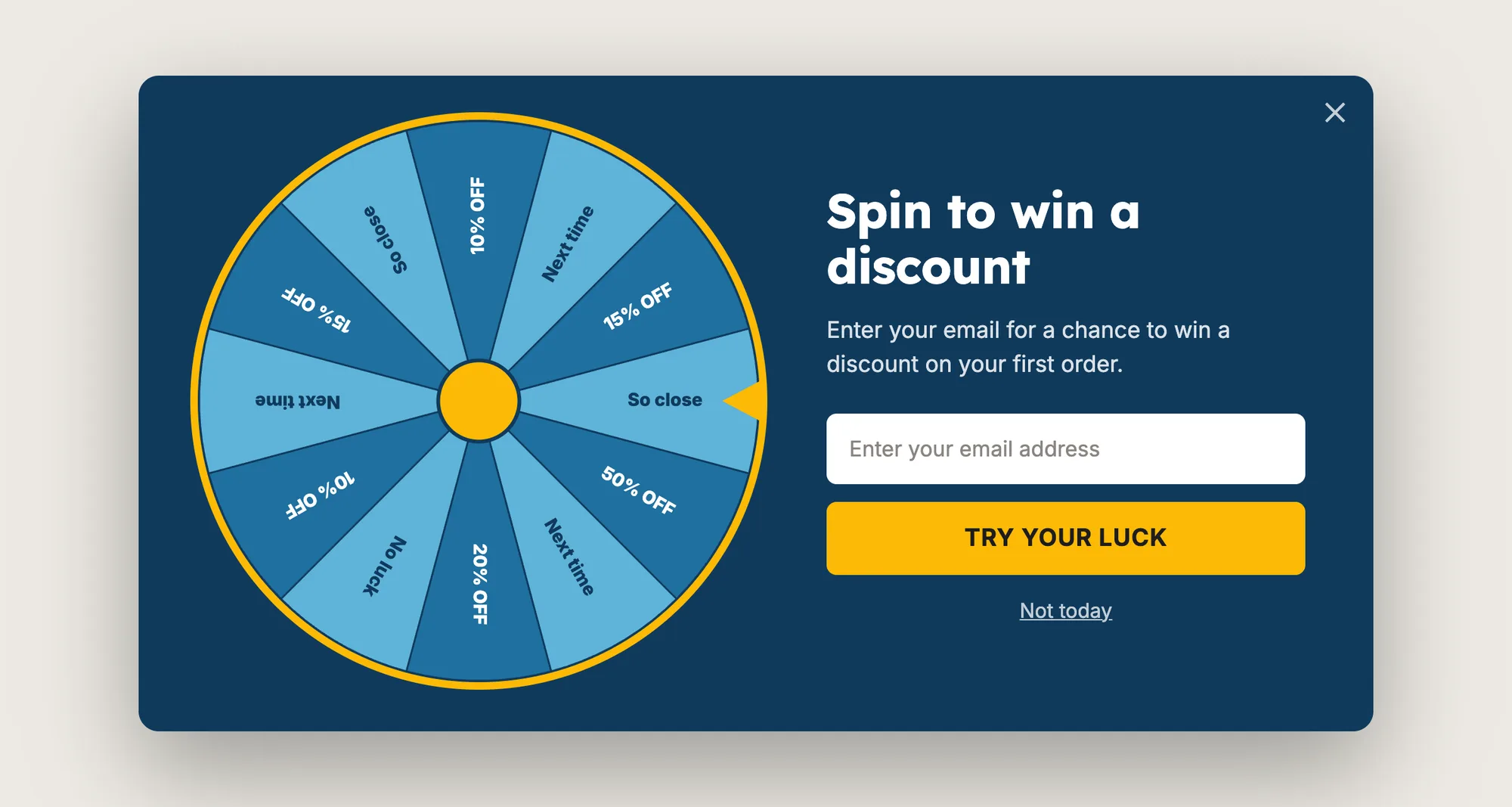 Close-up of a spin the wheel pop-up with a 12-slice discount wheel, an email field and a Try your luck button